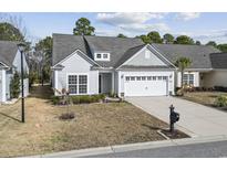 Charming single Gathering home features a manicured lawn, an attached two car garage and a gray roof at 2450 Craven Dr., Myrtle Beach, SC 29579