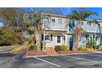 Two-story townhouse with balcony, palm trees, and parking at 3866 Highway 17 Business South # C-10, Murrells Inlet, SC 29576
