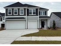 Two story home with gray siding, dark shutters, a two car garage, and concrete driveway at 4023 Bucolic Loop, Myrtle Beach, SC 29588