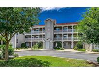Charming condo building featuring multi-story balconies and well-manicured landscaping at 4200 Coquina Harbour Dr. # H3, Little River, SC 29566