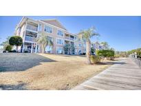 Exterior of a condo building with a walkway and landscaping at 4629 Lightkeepers Way # 6-I, Little River, SC 29566
