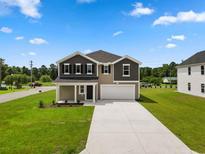 Two-story house with gray siding, white trim, and a two-car garage at 49 Cape Point Dr., Conway, SC 29527