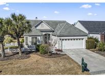 Attractive single-story home with a two-car garage and landscaped yard at 5719 Coquina Point Dr., North Myrtle Beach, SC 29582