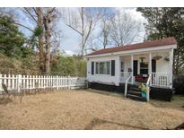 Charming white cottage with a red roof, white picket fence, and small front yard at 514 Palm St., Georgetown, SC 29440
