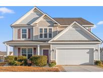 Two-story house with gray siding, a double garage, and landscaping at 556 Majorca Loop, Myrtle Beach, SC 29579