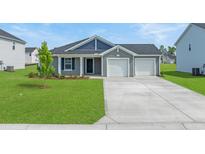 Charming single-story home showcasing a well-manicured lawn and a two-car garage at 57 Cape Point Dr., Conway, SC 29527