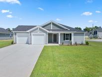 Newly constructed home with gray siding, two-car garage, and landscaped lawn at 57 Cape Point Dr., Conway, SC 29527