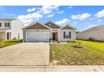 Charming single-Gathering home featuring a neat front yard and attached two-car garage at 589 Talisman Trail, Longs, SC 29568