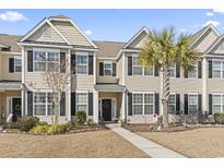 Tan two-story townhome with dark accents and palm tree at 636 Pistoia Ln., Myrtle Beach, SC 29579