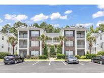 Attractive brick building with ample parking and lush landscaping at 1310 River Oaks Dr. # 2K, Myrtle Beach, SC 29579