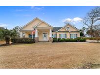 Inviting one-story home featuring a charming facade and manicured lawn at 1511 25Th Ave. N, North Myrtle Beach, SC 29582