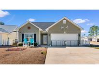 Charming single-story home features a well-maintained lawn, a two-car garage, and lovely exterior details at 185 Sebring Ln., Myrtle Beach, SC 29588