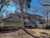Attractive exterior of a condo with a gray facade and a nicely landscaped front yard at 211 Baslow Ct. # 2-D, Myrtle Beach, SC 29572