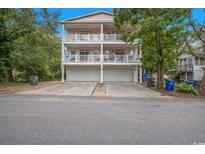 Two-story exterior featuring double balconies and a two-car garage at 3501 Dunes St. # 2, North Myrtle Beach, SC 29582