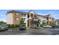Brick condo building with ample parking and landscaping; unit #312 highlighted at 3786 Hitchcock Way # 312, Myrtle Beach, SC 29577