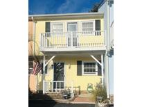 Charming yellow two-story home with balcony and American flag at 3866 Highway 17 Business # C-3, Murrells Inlet, SC 29576