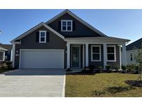 Two-story house with gray siding, white garage door, and a landscaped lawn at 394 Wingspan Ct., Myrtle Beach, SC 29588