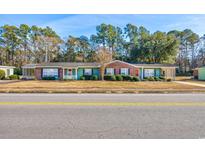 Front view of charming brick ranch houses with green accents at 534 Juniper Dr. # 534, Myrtle Beach, SC 29577