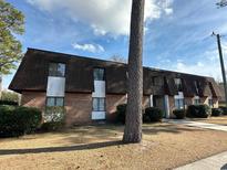 Brick building exterior with a brown roof and landscaping at 615 Carter Ln. # B4, Conway, SC 29526