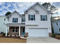 Two-story house with light-colored siding, brick accents, and a two-car garage at 7010 Shooting Star Way, Myrtle Beach, SC 29579
