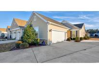 Tan colored house with a two-car garage and landscaping at 840 San Marco Ct. # D, Myrtle Beach, SC 29579