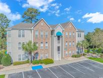 Two-story condo building with brick and siding accents, ample parking, and landscaping at 9772 Leyland Dr. # 10, Myrtle Beach, SC 29572