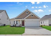 Charming single-story home with a two-car garage, manicured lawn, and beautiful architectural details at 1208 Nw Calabash Station Blvd., Calabash, NC 28467