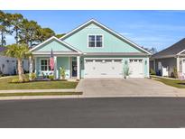 Charming home featuring a three-car garage and a beautifully landscaped front yard with an American flag at 1357 Jolly Roger Dr., North Myrtle Beach, SC 29582