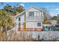 Two-story house with private deck, fenced yard, and a swimming pool at 1521 Edge Dr., North Myrtle Beach, SC 29582