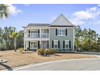 Two-story house with gray siding, white accents, and a balcony at 208 Switch Grass Ct., Myrtle Beach, SC 29579