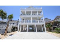 Expansive three-story beach home featuring multiple decks and ample covered parking at 229 South Waccamaw Dr., Garden City Beach, SC 29576