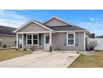 Gray house with white shutters, small front yard, and a concrete driveway at 408 Pigeon Bay St., Longs, SC 29568