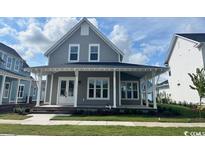 Two-story home with gray siding, white trim, and a front porch at 512 Ayrhill Loop, Myrtle Beach, SC 29588