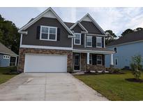Two-story home with gray siding, stone accents, and a two-car garage at 578 Haven View Way, Murrells Inlet, SC 29576