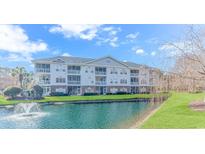 Exterior of a multi-unit building with pond and fountain at 5825 Catalina Dr. # 122, North Myrtle Beach, SC 29582