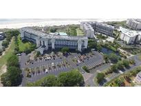 Aerial view of beachfront resort complex with pool and parking at 601 Retreat Beach Circle # 124, Pawleys Island, SC 29585