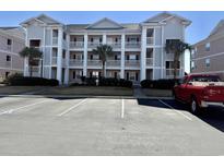 Three-story building exterior with parking lot and landscaping at 636 Waterway Village Blvd. # 17C, Myrtle Beach, SC 29579