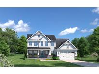Two-story home with stone accents, a two-car garage, and a landscaped lawn at 8008 Lotus Dr, Myrtle Beach, SC 29579