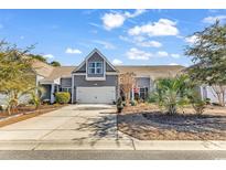Attractive exterior of a two-story house with a two-car garage and well-manicured landscaping at 834 Arezzo Way # 834, Myrtle Beach, SC 29579