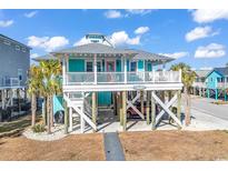 Charming elevated beach house with a spacious deck and ocean views at 923 N Waccamaw Dr., Garden City Beach, SC 29576
