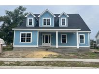 Charming blue house with white trim, dormer windows, and a welcoming front porch at 1004 James Island Ave., North Myrtle Beach, SC 29582