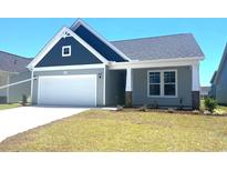 Newly constructed home with gray siding, white trim, and a two-car garage at 1099 Nw Forest Bend Dr., Calabash, NC 28467