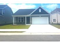 Charming single-story home features a well-manicured lawn and a classic, inviting facade at 1099 Nw Forest Bend Dr., Calabash, NC 28467