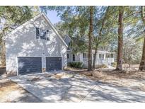 Two-story house with a two-car garage and wraparound porch at 117 George Washington Trail, Georgetown, SC 29440