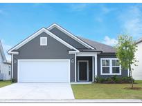 Charming single-Gathering home with gray siding, a two-car garage, and a well-manicured lawn at 1336 Winding Creek Way, Myrtle Beach, SC 29588