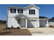 Charming two-story home with white siding and a spacious three car garage, perfect for a growing Gathering at 1508 Clubstone Dr., Conway, SC 29526