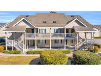 Two-story building with multiple units, balconies, and landscaping at 1870 Auburn Ln. # 21J, Surfside Beach, SC 29575