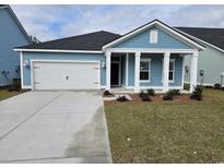 Charming one-story home with a two-car garage, covered porch, and light blue siding at 1912 Seachase Way, North Myrtle Beach, SC 29582