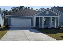 Charming single-Gathering home featuring a two-car garage and welcoming covered porch at 1912 Seachase Way, North Myrtle Beach, SC 29582