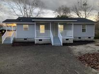 Charming single-story home featuring a covered front porch and a freshly landscaped yard at 206 W Pine St., Johnsonville, SC 29555